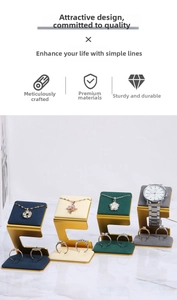 Detail of luxury jewelry display stand with golden C-shape bases and colorful velvet pads