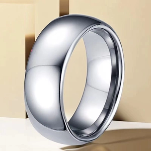 Macro shot of wide curved silver stainless steel ring with polished metallic finish