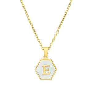 Detail view of a gold hexagonal pendant with white shell inlay and 3D letter E