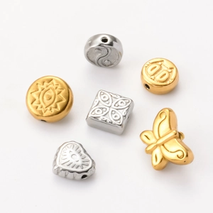 Macro shot of assorted stainless steel beads in gold and silver for DIY jewelry making