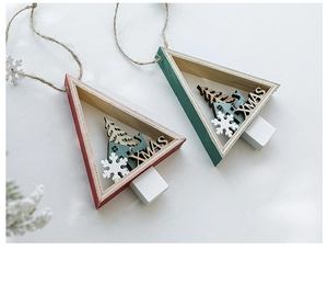 Detail of red and green wooden triangle Christmas ornaments with XMAS engraving and twine