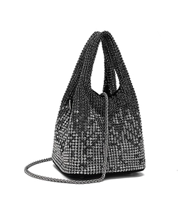 Close-up of sparkling silver gradient rhinestones on bucket bag with metal chain