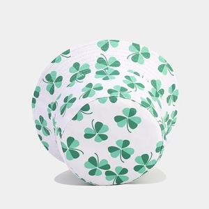 White bucket hat with green clover print in a high-quality 45-degree angled view
