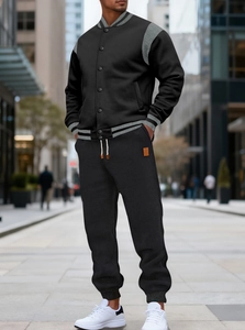 Detail of drawstring waist and leather label on black brushed fleece jogger pants