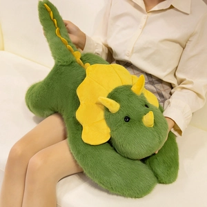 Cute green triceratops plush dinosaur pillow toy being held for size demonstration