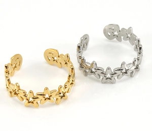 Detail of adjustable star cutout rings in gold and silver stainless steel finishes