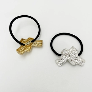 Detailed view of elastic U-shaped hair ties with textured gold and silver alloy accents