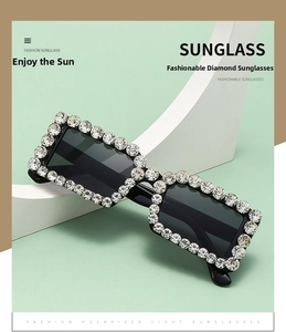 Macro view of luxury square sunglasses with rhinestones on a minimalist background