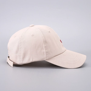 Detail view of cotton baseball cap with red heart embroidery and metal buckle strap