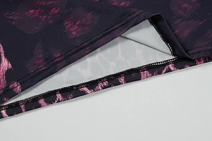 Close-up of double-needle stitching and leopard print fabric on a purple dress