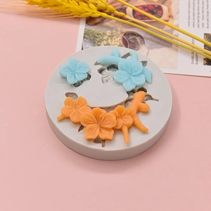 Macro view of silicone mold for cherry blossom resin crafts on a pink decorative background