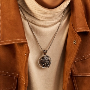 Detailed view of silver Jesus head pendant with thorn crown on a stainless steel necklace