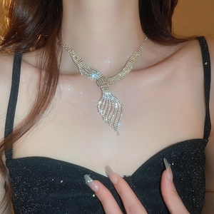 Close-up of sparkling rhinestone leaf necklace on model for elegant bridal evening wear