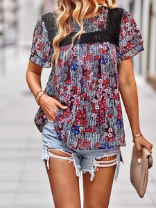 Detail of floral print top with black lace square neckline and ruffled short sleeves