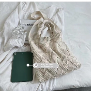 Chunky knit tote bag in beige with 3D diamond texture next to iPad for size scale