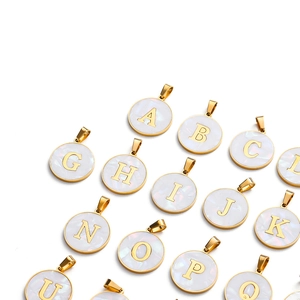Detailed view of gold stainless steel shell letter pendants for DIY jewelry making