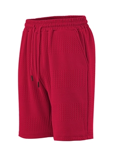 Close-up of red waffle knit texture on men's casual shorts with drawstring waist
