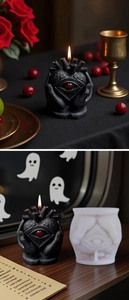 Macro view of gothic hand-holding eye heart candle and its white silicone mold details