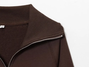 Macro view of dark brown fleece sweatshirt zipper and ribbed collar detail in size S