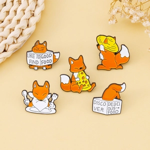 Set of five cute orange fox enamel pins with pizza and foodie themes on a beige background