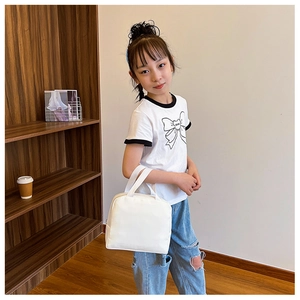 Close-up of child holding a white insulated lunch bag with comfortable dual handles