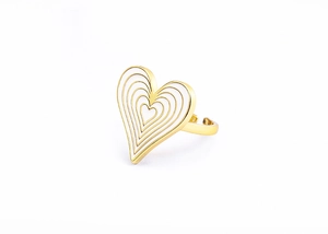 Detail of gold heart ring with white enamel accents and layered concentric texture