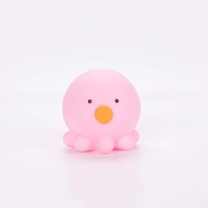 Close-up of pink octopus night light with orange mouth and soft silicone texture