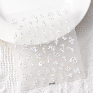 Macro detail of TS-065 white 5D embossed nail stickers featuring rose and tulip patterns