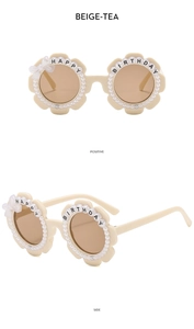 Detail of beige tea flower sunglasses with white pearls and Happy Birthday text decoration