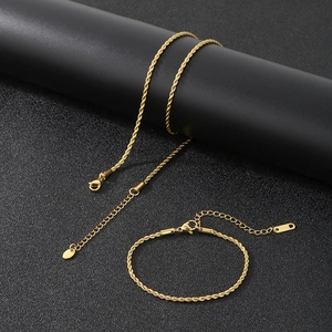 Detail of gold twisted rope chain necklace and bracelet set with S.STEEL hallmark