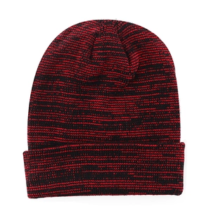 Detail of red and black melange knit texture and folded cuff on a warm winter beanie