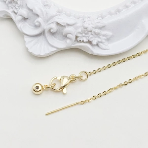 Detail of adjustable 14k gold chain with lobster clasp and needle pin for DIY jewelry
