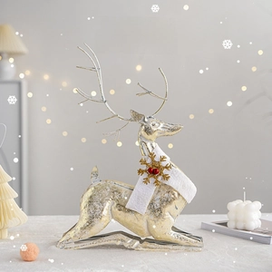 Golden reindeer Christmas ornament with white scarf and snowflake on a cozy tabletop