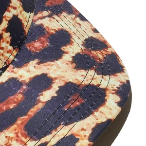 Close-up of leopard print baseball cap featuring reinforced stitching on the brim detail