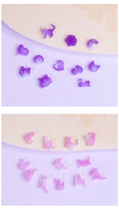 Detail of pink and purple cat-shaped resin charms and moon elements for DIY jewelry