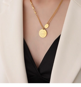 Close-up of double layer gold necklace with engraved BELOVED round pendants on model