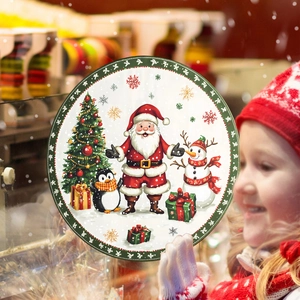 Close-up of a child holding a round Christmas tray with Santa and festive patterns