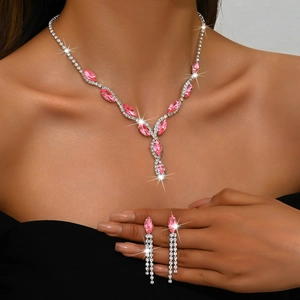 Luxurious silver necklace set with pink marquise stones and crystal tassels on a model