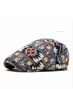 Detail view of ethnic geometric jacquard flat cap in blue with metal buckle