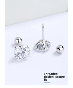 Macro detail of screw-back stud earrings featuring four-prong cubic zirconia and thread structure