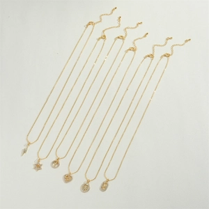 Close-up of 14K gold plated necklace set with star, lightning, and heart zircon charms