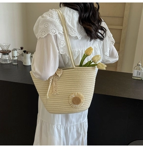 Detail of handwoven tote bag featuring 3D daisy flowers and delicate lace trim accents