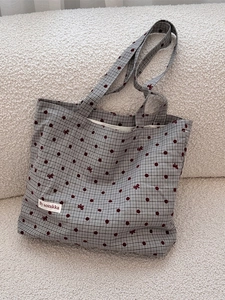 Chic canvas tote bag with black and white plaid, red polka dots, and bow patterns
