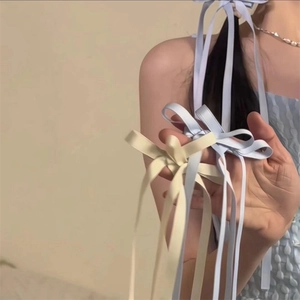 Elegant satin bow hair clip with long ribbons in light blue and cream for women