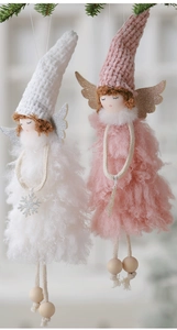 Detail of plush Christmas angel dolls with glittery wings and wooden beads on pine branch
