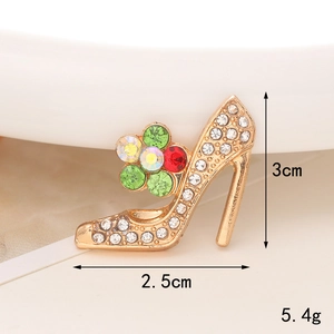 Macro shot of a golden stiletto brooch with colorful floral rhinestones, size 3x2.5cm