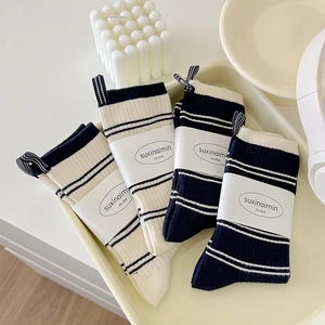 Four pairs of striped cotton mid-calf socks in navy and cream with knit pull tabs