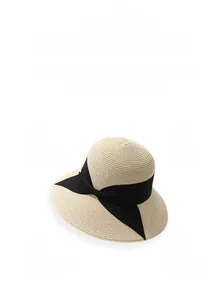 Detail of breathable paper straw weave and elegant black silk bow on sun hat