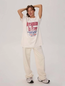 Dettaglio della t-shirt oversize bianca in cotone con stampa vintage Dreaming Is Free