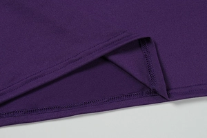 Detail view of double-stitched hem on high-density purple knit dress with smooth texture